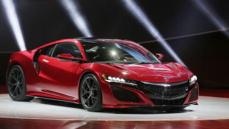 Sleek Red Supercar in Spotlight wallpaper