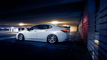 Sleek White Car in Urban Setting at Night wallpaper