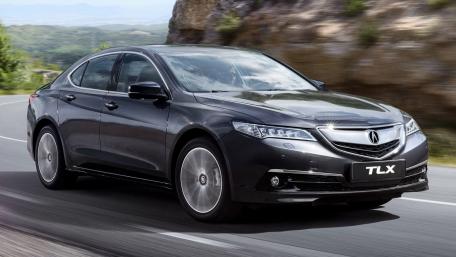Sleek Black TLX Sports Sedan on the Road wallpaper