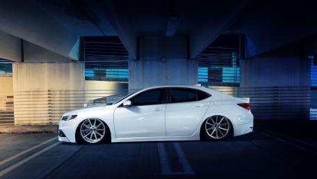 Sleek White Sedan in Urban Setting wallpaper