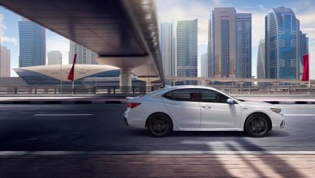 Sleek White Car Against Urban Skyline Scene wallpaper
