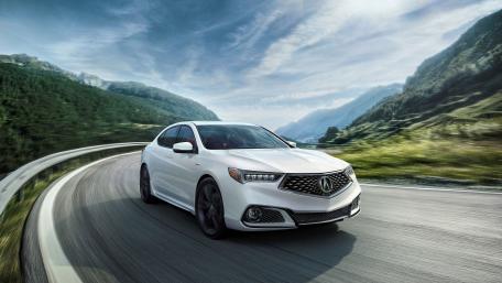 Sleek and Powerful White Car on a Scenic Road wallpaper