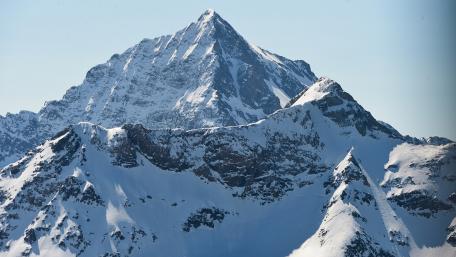 Majestic Snow-Capped Peaks Rising Above the Landscape wallpaper