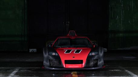 Sleek Red Race Car in the Shadows wallpaper