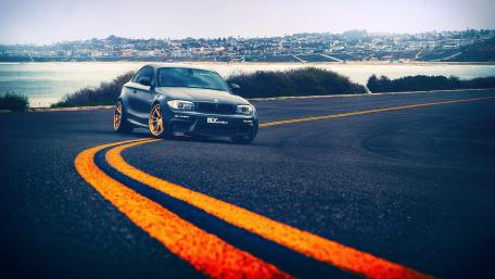 Sleek Car on a Scenic Coastal Road wallpaper