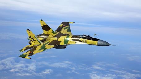 Sleek Fighter Jet in Action Above the Clouds wallpaper