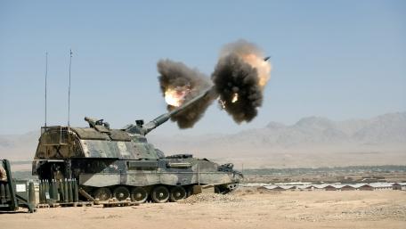 Heavy Artillery in Action amid Desert Landscape wallpaper