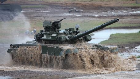 Battle Ready Tank in Action on Muddy Terrain wallpaper
