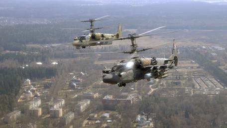 Military Helicopters in Action Above the Landscape wallpaper