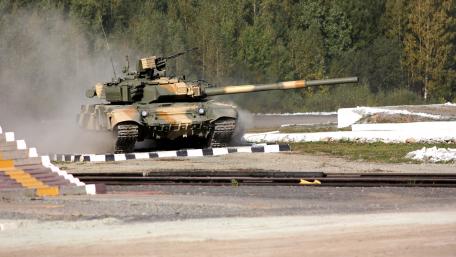 Tank Maneuvering Through Dusty Terrain wallpaper