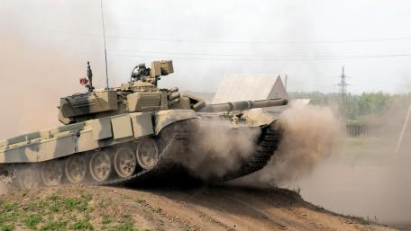 Powerful Tank in Action Amid Dust Storms wallpaper