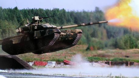 Powerful Tank in Action Over a Battlefield Scene wallpaper