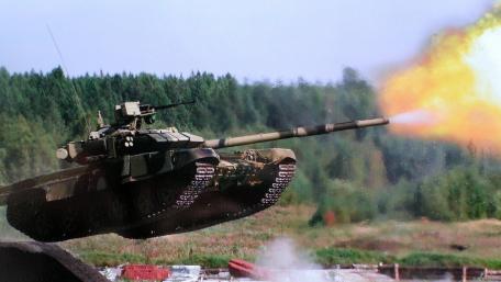 Powerful Tank in Action Against a Natural Backdrop wallpaper