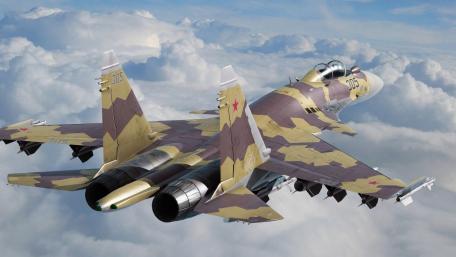Sleek Fighter Jet Soaring Through Clouds wallpaper