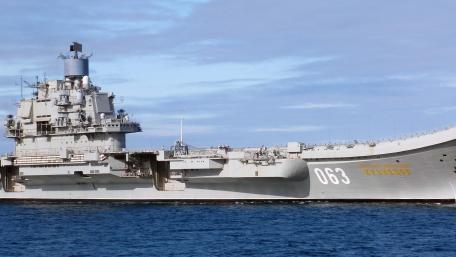 Majestic Aircraft Carrier Sailing the Ocean Waves wallpaper