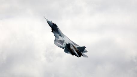 Majestic Fighter Jet Maneuvering Through Clouds wallpaper