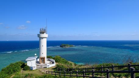 Lighthouse on the Cliff Overlooking Turquoise Waters wallpaper