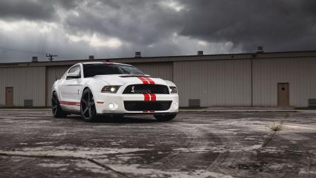 Sleek White Muscle Car Under Dramatic Skies wallpaper