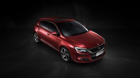 Sleek Red Sedan in Dark Background wallpaper