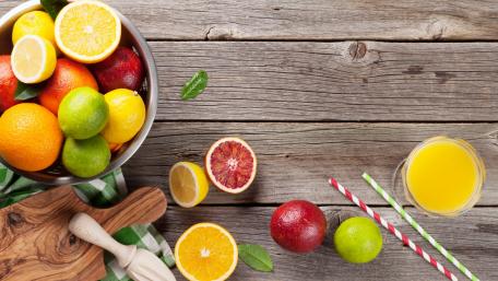Vibrant Citrus Fruits on Rustic Tabletop wallpaper