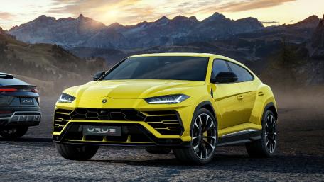 Bold Yellow Lamborghini SUV in Scenic Landscape wallpaper