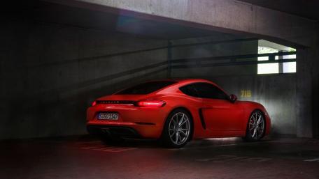 Sleek Red Sports Car in a Dimly Lit Garage wallpaper