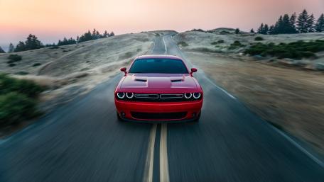 Red Muscle Car on Open Road at Dusk wallpaper