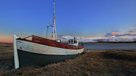 Serene Abandonment of a Boat by the Shore wallpaper