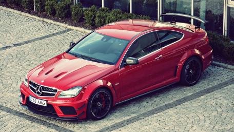 Sleek Red Mercedes AMG on Cobblestone Driveway wallpaper