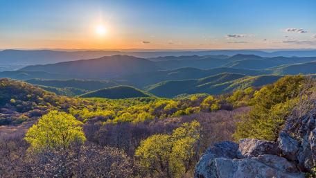 Serene Sunset Over Lush Mountain Ranges wallpaper