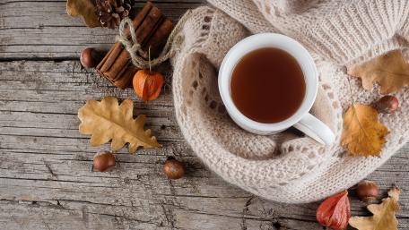 Warm Autumn Beverage and Comforting Foliage Display wallpaper