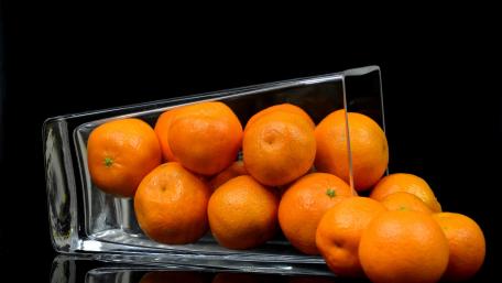 Vibrant Oranges in a Glass Container wallpaper