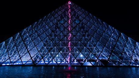 Glowing Pyramid at Night Cityscape Wallpaper wallpaper
