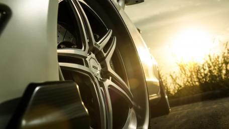 Sleek Wheels Against a Glowing Sunset wallpaper