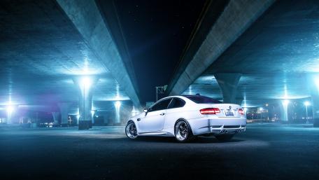 Sleek White Car Under Urban Lights wallpaper