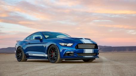 Sleek Blue Mustang Against a Stunning Sunset wallpaper