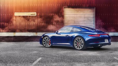 Sleek Blue Porsche Shines in Urban Landscape wallpaper