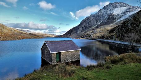 Serene Lake with Boathouse in Stunning Landscape wallpaper