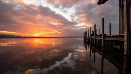 Serene Sunset Over Pier Reflection wallpaper