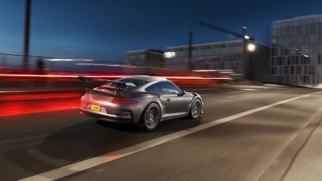 Sleek Porsche in Motion at Nighttime Magic wallpaper