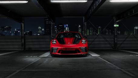 Striking Red Sports Car in Urban Setting wallpaper
