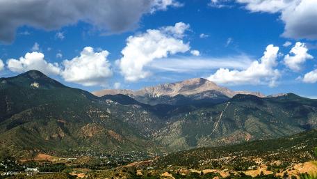 Majestic Mountain Range Under a Blue Sky wallpaper