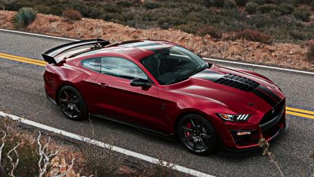 Sleek Red Sports Car on Open Road wallpaper