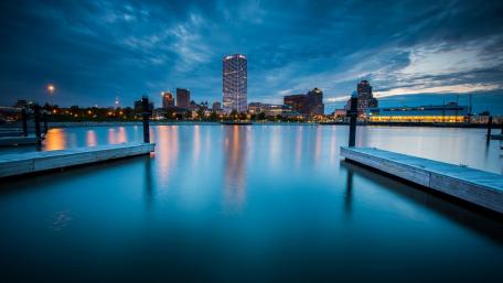 Serene Cityscape at Dusk Over Water wallpaper