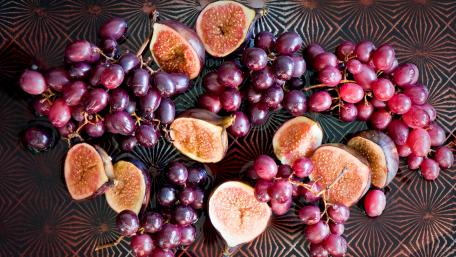 Vibrant Grapes and Figs Arranged Artistically wallpaper