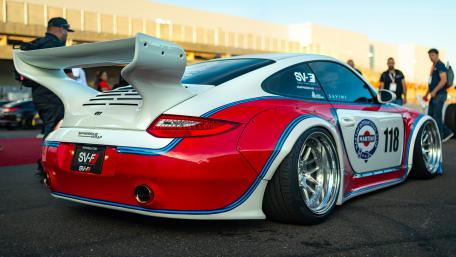Sporty Racing Car with Bold Colors in Action wallpaper