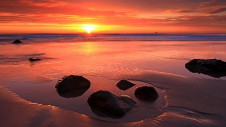 Serene Sunset Over Tranquil Ocean Shoreline wallpaper