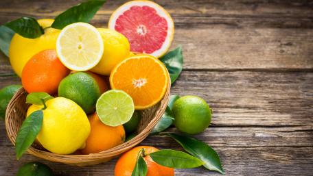 Vibrant Citrus Fruits in a Rustic Basket wallpaper