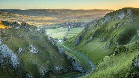 Breathtaking Valley Landscape Under Golden Sunrise wallpaper