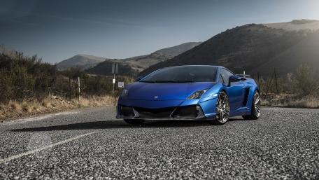 Sleek Blue Supercar on a Mountain Road wallpaper